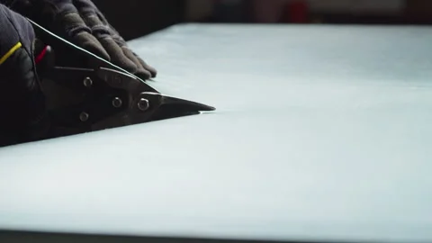 Worker cutting aluminium with scissors, professional builder, metal factory Stock Footage 223023902