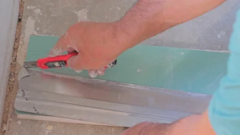 Worker cutting and applying plasterboard material to the wall Stock Footage 142954767