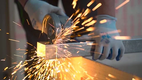 Worker Cutting Angle Iron with Sparks Video Stock Footage 313713650