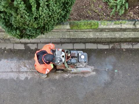 Worker cutting asphalt Stock Photos