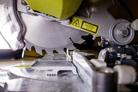 Worker cutting baseboard on the circular saw before installing Stock Photos