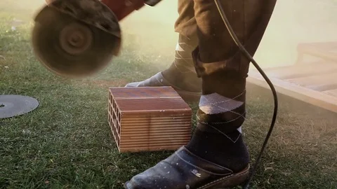 Worker cutting the bricke with drill Stock Footage 75770256