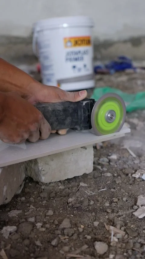 Worker Cutting Ceramic Tile with Electric Angle Grinder on Construction Site Stock-Footage 342883013