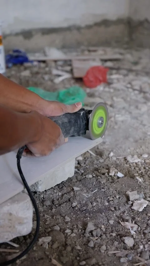 Worker Cutting Ceramic Tile with Electric Angle Grinder on Construction Site Stock-Footage 342883100