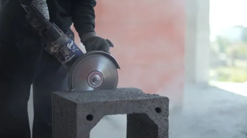 Worker cutting concrete block with circular saw at construction site Stock Footage 318588772