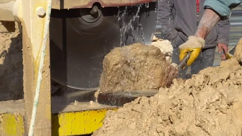 Worker cutting concrete pile column by electric cutting machine. Stock Footage 85458442