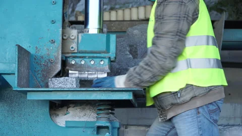 A worker cutting cube setts Stock Footage 237340784