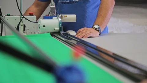 Worker cutting a fabric with cutting machine Stock Footage 69855549
