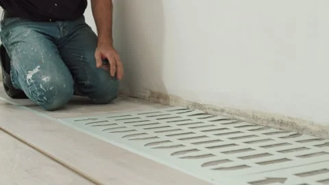Worker Cutting Foam Underlayment Sheet to Fit Wall Stock Footage 322055538