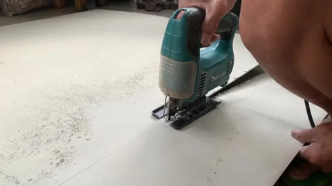 A worker is cutting GRC material with a chainsaw cutting tool in a DIY workshop Stock Footage 268956902