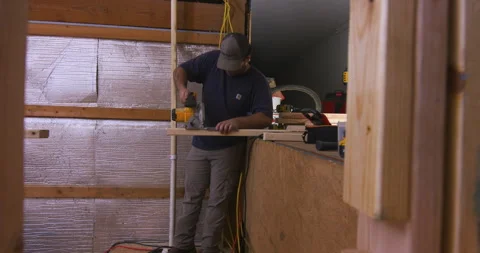 Worker Cutting Lumber Inside Framed Structure Stock Footage 342839303