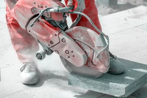 Worker cutting marble tile with electric hand saw Stock Photos