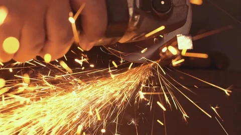 Worker cutting metal with angle grinder creating sparks Stock-Footage 306584962