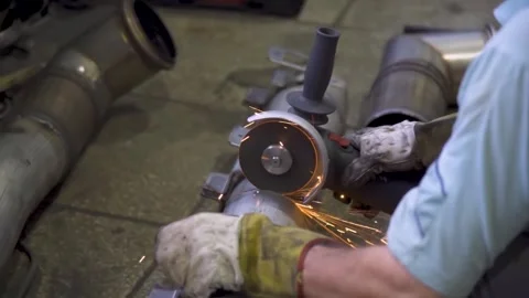 Worker cutting metal with angle grinder, close-up with sparks Stock Footage 314057375
