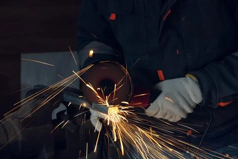 Worker Cutting Metal with Angle Grinder with Sparks 스톡 사진