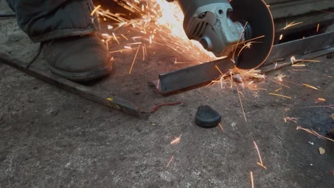 Worker cutting metal bar with angle grinder producing sparks Stock-Footage 333697261