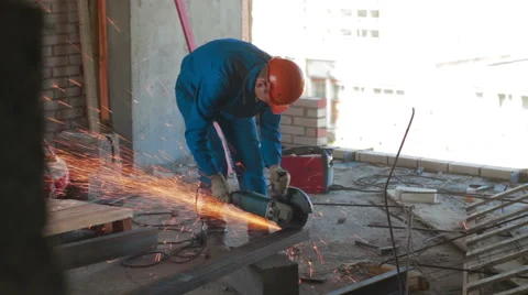 Worker cutting metal beam with grinder Stock Footage 57724984