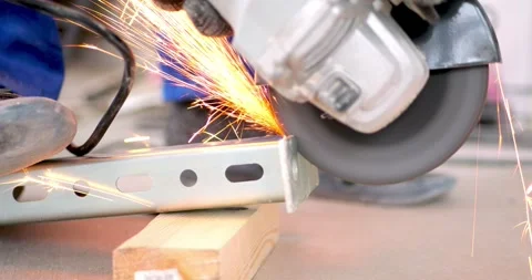 Worker Cutting Metal Bracket Angle Grinder Abrasive Disc Sparks Flying Stock Footage 330954700