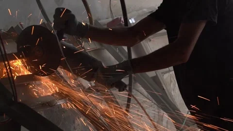 A worker cutting metal with an electric angle grinder Stock Footage 294261890