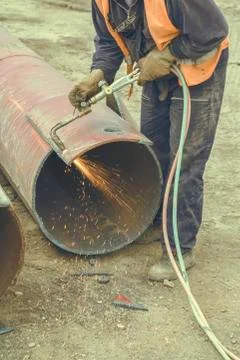 Worker cutting metal with flame torch Stock Photos