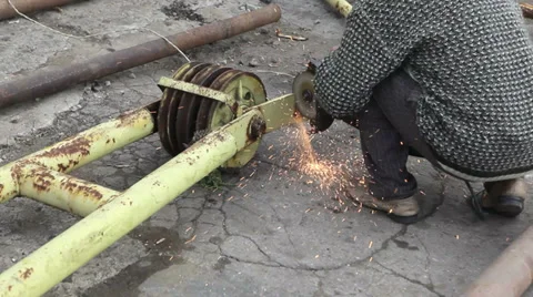 Worker cutting metal frame with grinder and flashing sparks Stock Footage 36524766