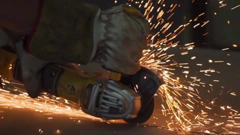 Worker cutting metal with grinder dramatic sparks in close-up industrial shot Stock Footage 306179684