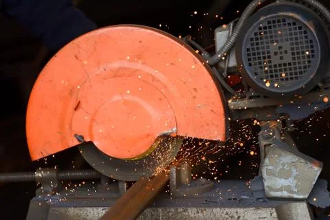 Worker cutting metal with grinder Stock Photos