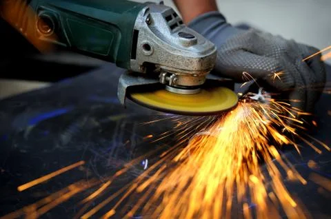 Worker cutting metal with grinder 写真素材