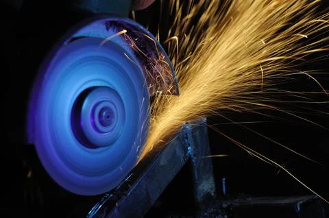 Worker cutting metal with grinder Stock Photos