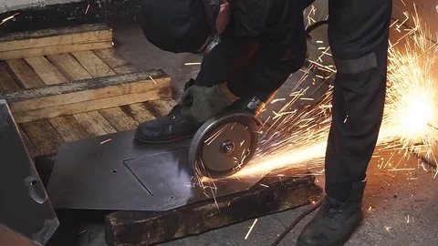 Worker cutting metal with many sharp sparks Stock Footage 83795517