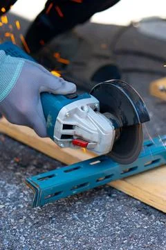 Worker cutting metal with many sharp sparks using equipments to cut iron Stock Photos
