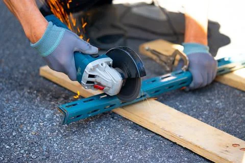 Worker cutting metal with many sharp sparks using equipments to cut iron Stock Photos