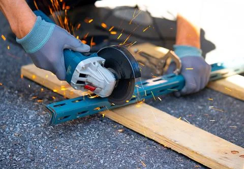 Worker cutting metal with many sharp sparks using equipments to cut iron 스톡 사진