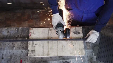 Worker cutting metal plank with angle grinder Stock Footage 142333251