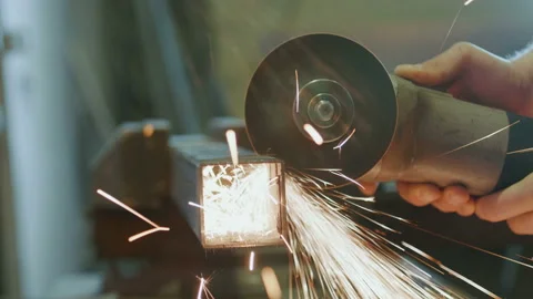 Worker cutting metal with a power tool Stock Footage 89551471