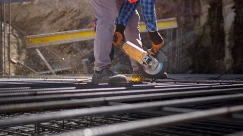 Worker Cutting Metal Rebar with Angle Grinder on Construction Site Stock Footage 278657267