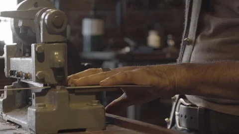 Worker cutting metal stripes with a cutting machine Stock Footage 87613140