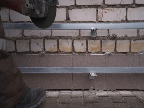 Worker cutting the metal structure through angular grinding machine, sparks. 4k Video stock 73029632