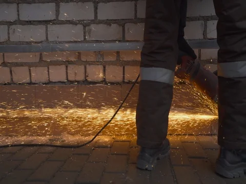 Worker cutting the metal structure through angular grinding machine, sparks. Stock Footage 73039875