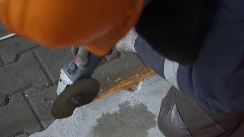 Worker cutting the metal structure through angular grinding machine, sparks. Stock Footage 73215116