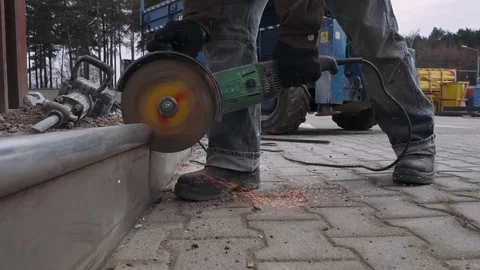 Worker cutting the metal structure through angular grinding machine. Stock Footage 74732671