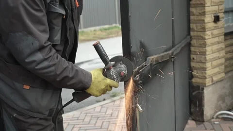 Worker cutting metal tube using an Angle Grinder. Bright sparks and flashes Stock Footage 259027218