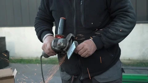 Worker cutting metal tube using an Angle Grinder. Bright sparks and flashes Stock Footage 259027222
