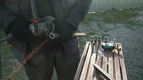 Worker cutting metal tube using an Angle Grinder. Bright sparks and flashes Stock-Footage 259027466