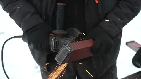 Worker cutting metal tube using an Angle Grinder. Bright sparks and flashes Video stock 259027532