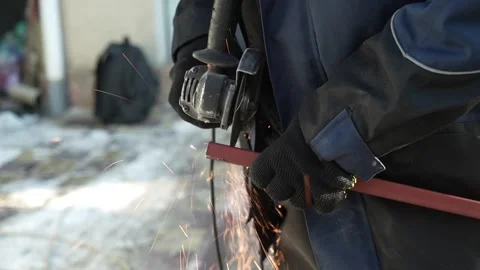 Worker cutting metal tube using an Angle Grinder. Bright sparks and flashes Stock-Footage 259027549