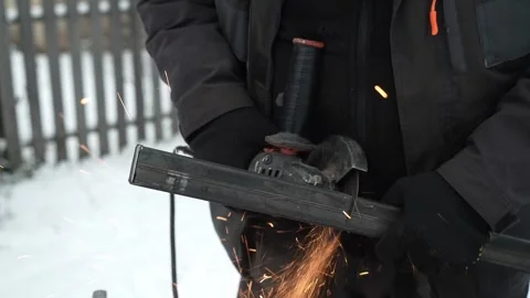 Worker cutting metal tube using an Angle Grinder. Bright sparks and flashes Stock-Footage 259027554