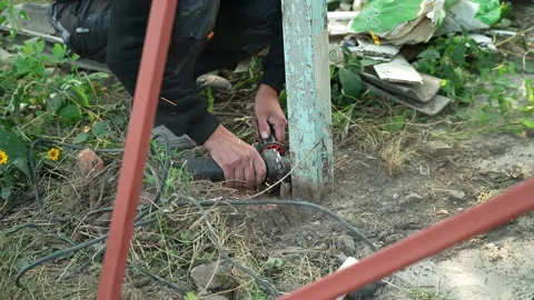 Worker cutting metal tube using an Angle Grinder. Bright sparks and flashes Stock-Footage 259027600