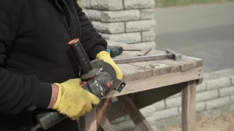 Worker cutting metal tube using an Angle Grinder. Bright sparks and flashes Video stock 259027651