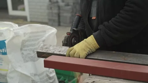 Worker cutting metal tube using an Angle Grinder. Bright sparks and flashes Stock-Footage 259027714